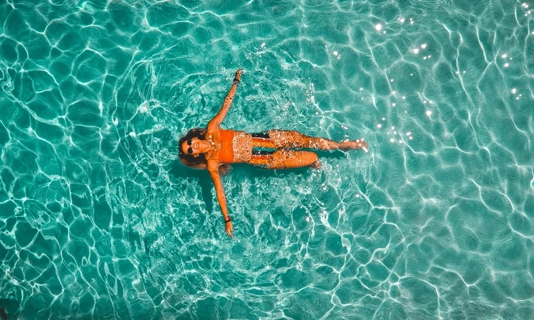 Women Floating In Pool